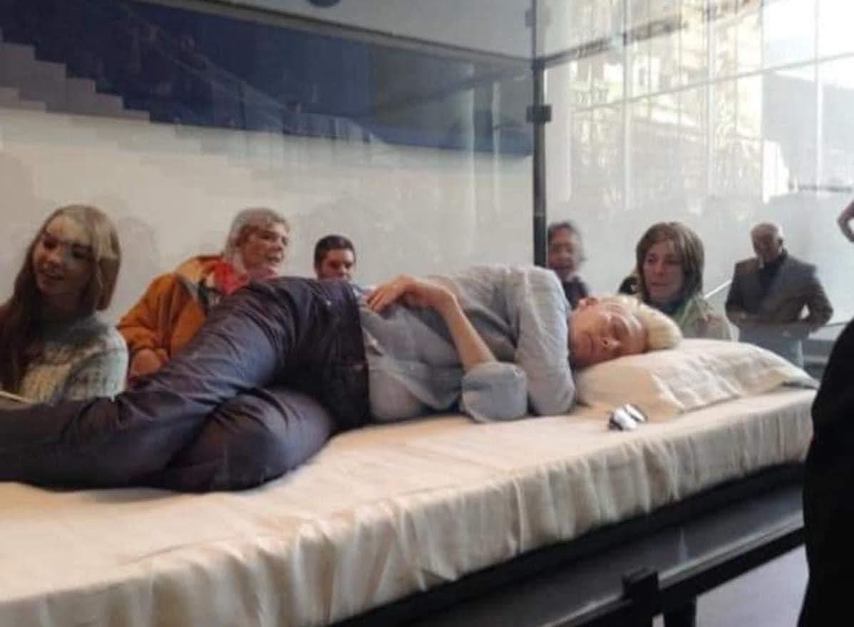 Mujer se encierra en urna de cristal a dormir para ser una obra de arte de museo